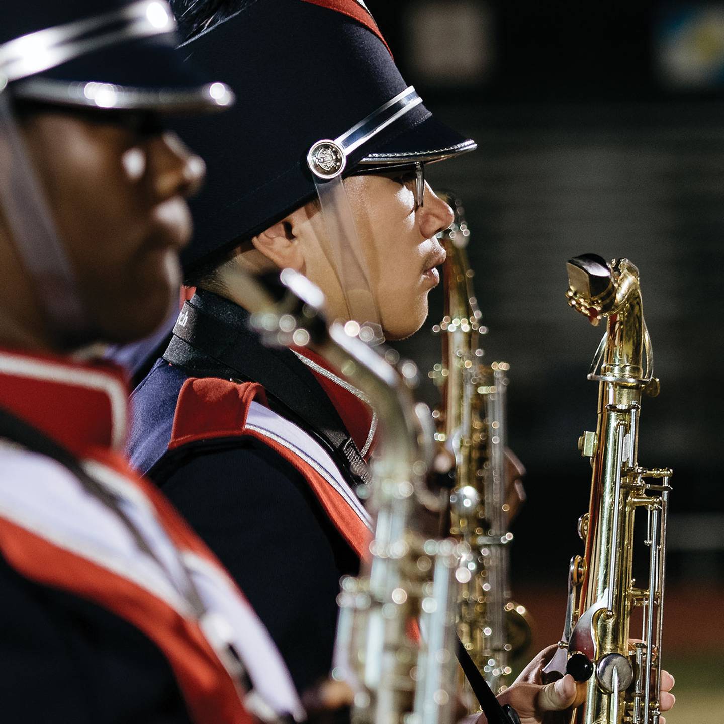 Close up of marching band saxaphone section.