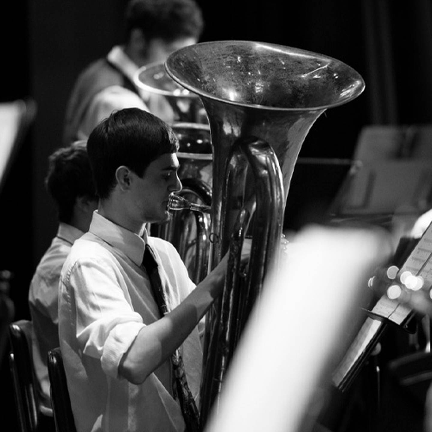 black and white image of music performer playing brass instrument